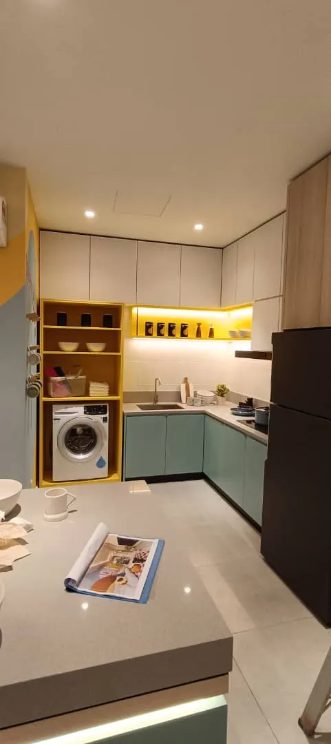 Kitchen with sage cabinets and a lit yellow shelf at Eco Majestic